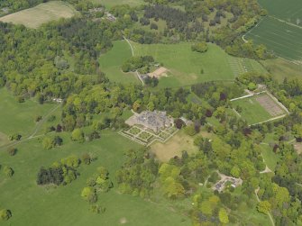 General oblique aerial view centred on the country house with the policies and gardens adjacent, taken from the  SSW.
