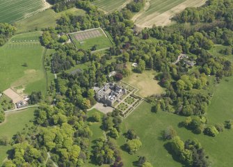 General oblique aerial view centred on the country house with the policies and gardens adjacent, taken from the  NW.