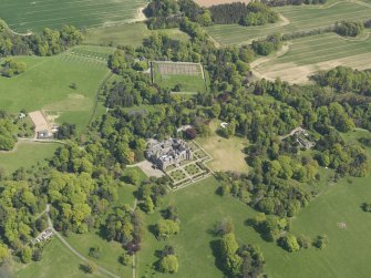 General oblique aerial view centred on the country house with the policies and gardens adjacent, taken from the  NW.