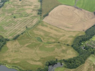 0blique aerial view of the parchmarks of the enclosure and settlement at Chapel Rossan, taken from the NE.