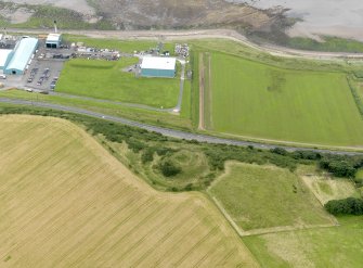 Oblique aerial view centred on the remains of the motte, taken from the E.