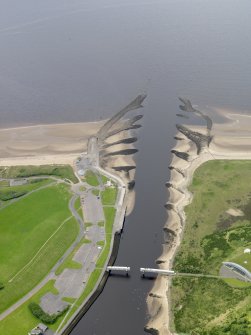 Oblique aerial view centred on the footbridge and breakwaters, taken from the NE.