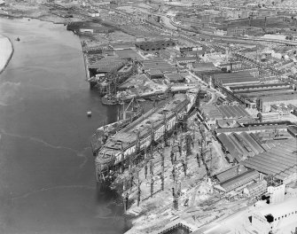 RMS Queen Mary, under construction in John Brown's shipyard, Clydebank. Oblique aerial view of the liner, from NE.