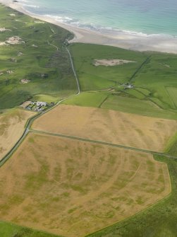 Oblique aerial view looking across the cropmarks of the trackway, possible enclosure and frost wedges towards Machir Bay, taken from the NE.