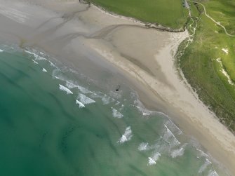 Oblique aerial view centred on the wreck of the craft on Traigh Mhachir, Islay, taken from the SW.