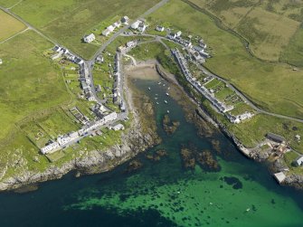 Oblique aerial view centred on the vilage of Portnahaven, taken from the SW.