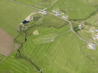 Oblique aerial view centred on the cemetery and the remains of the chapel at Nerabus, Islay, taken from the ESE.