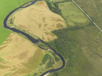 Oblique aerial view centred on the cropmarks of the enclosure and field boundaries at Island House, taken from the NE.