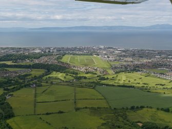 General oblique aerial view of the town centred on the racecourse with Arran and Kintyre in the distance, taken from the E.