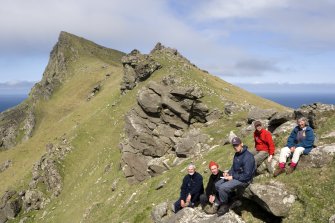 St Kilda, Hirta. Mullach Bi and the grass slopes above the cliffs viewed from S, with Ian Parker (RCAHMS), Bill Shaw (NTS), Alex Hale and James Hepher (RCAHMS), and Mary Harman (SNH).