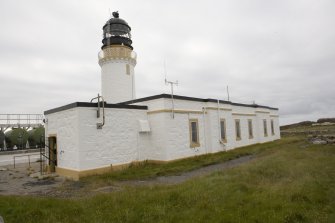 View from the E of the lighthouse keepers' cottages and lighthouse tower.