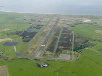 General oblique aerial view looking down the main runway at Machrihanish Airfield, taken from the E.