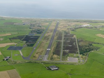 General oblique aerial view looking down the main runway at Machrihanish Airfield, taken from the E.