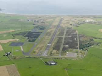 General oblique aerial view looking down the main runway at Machrihanish Airfield, taken from the E.