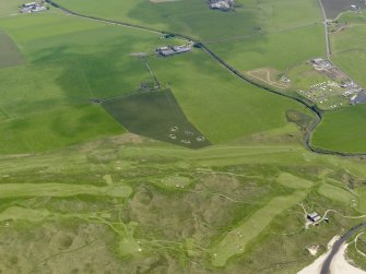 General oblique aerial view centred on the remains of the anit-aircraft battery and the golf course, taken from the NNW.