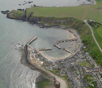 Oblique aerial view centred on the harbour with the Shorehead adjacent, taken from the NW.