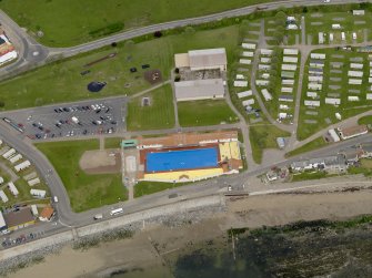 Oblique aerial view centred on the open air swimming pool with the Leisure Centre adjacent, taken from the SE.