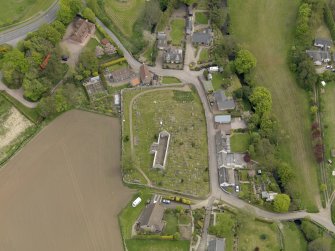 Oblique aerial view centred on the church with the graveyard adjacent, taken from the WSW.