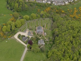 Oblique aerial view centred on the church with Dunnottar House adjacent, taken from the S.