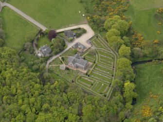 Oblique aerial view centred on the church with Dunnottar House adjacent, taken from the NE.