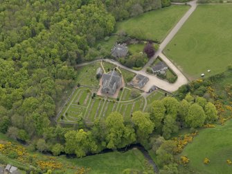 Oblique aerial view centred on the church with Dunnottar House adjacent, taken from the N.
