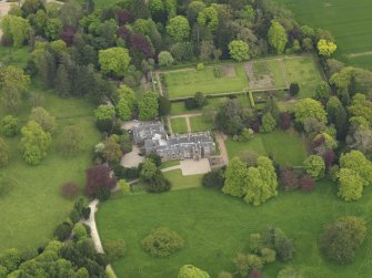 Oblique aerial view centred on the country house, taken from the WNW.