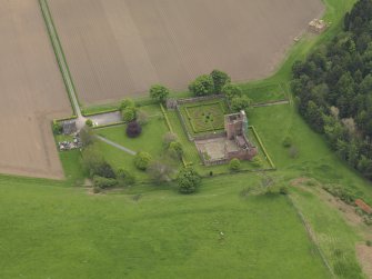 Oblique aerial view centred on the castle with the formal gardens adjacent, taken from the NNW.