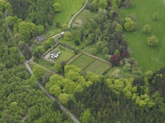 Oblique aerial view centred on the walled garden and cottage, taken from the NW.