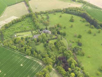 General oblique aerial view of the tower house with the gardens and stables adjacent, taken from the NW.