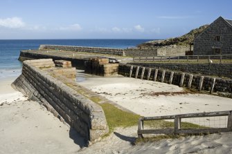 View of dock and harbour walls from W