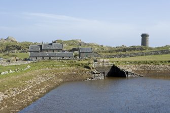 Reservoir, sluice gates and complex with signal tower, view from NW