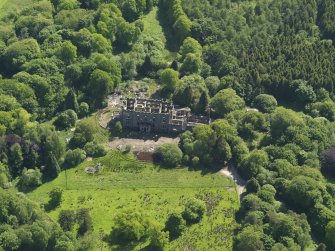 Oblique aerial view centred on the remains of the country house, taken from the NE.