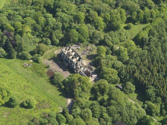 Oblique aerial view centred on the remains of the country house, taken from the NNW.