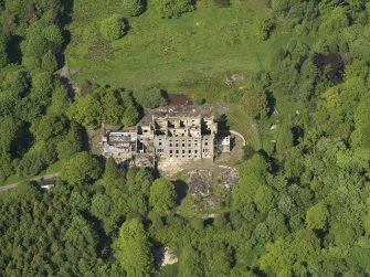 Oblique aerial view centred on the remains of the country house, taken from the SW.