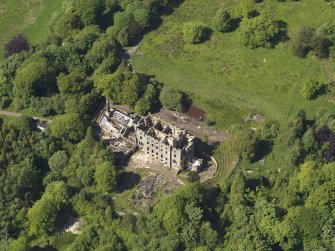 Oblique aerial view centred on the remains of the country house, taken from the S.