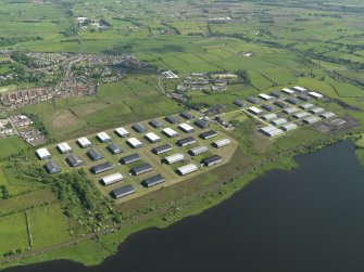 Oblique aerial view centred on the industrial estate, taken from the NW.