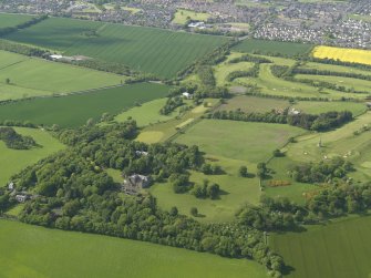 General oblique aerial view centred on the house with the policies adjacent, taken from the SE.