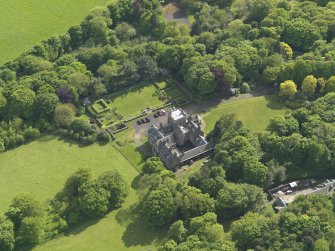 Oblique aerial view centred on the house with the terraced garden adjacent, taken from the NE.