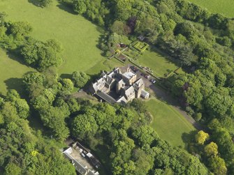 Oblique aerial view centred on the house with the terraced garden adjacent, taken from the NW.