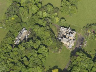 Oblique aerial view centred on the house with the terraced garden adjacent, taken from the W.