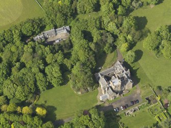 Oblique aerial view centred on the house with the terraced garden adjacent, taken from the SW.
