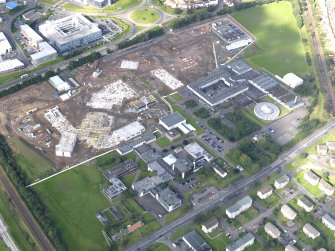 Oblique aerial view of Forrester Secondary and St Augustine RC High schools from SE, with construction site of new schools to the  W.