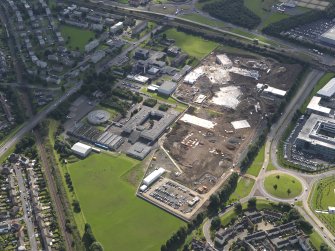 Oblique aerial view centred on St Augustine RC High and Forrester Secondary schools and construction site of new schools to W, taken from the NW.