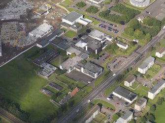 Oblique aerial view of Forrester Secondary school with construction site of new school to W, taken from the SE.
