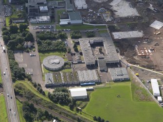 Oblique aerial view of St Augustines RC High school  with construction site for new school to W, taken from the N.