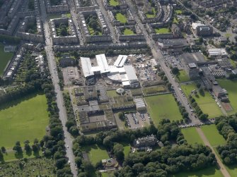 Oblique aerial view centred on Broughton High School and construction site of new school, with Edinburgh City Police HQ to SW, taken from the N.
