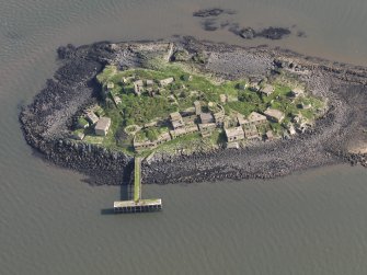 Oblique aerial view of Inchmickery centred on the 20th century military remains (NT28SW 1.00), taken from the WSW.
