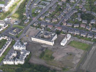 Oblique aerial view centred on Ainlsie Park High School, Pilton, taken from the SSE.