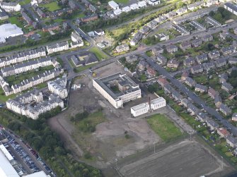 Oblique aerial view centred on Ainslie Park High School, Pilton, taken from the SE.