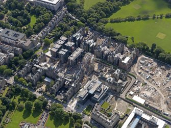 Oblique aerial view centred on the Quartermile development and the former Edinburgh Royal Infirmary, taken from the NNW.